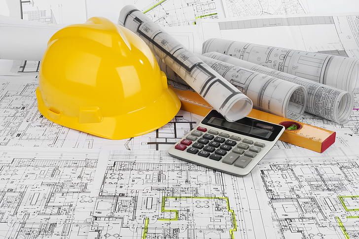 Engineering drawings, hard hat and calculator